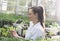 Woman agronomist with tablet and microscope in greenhouse