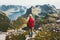 Woman alone with backpack exploring mountains of Norway