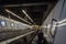 Woman alone going down an escalator with a speed blur movement, rushing to reach the platform of a metro station of Vienna