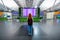 Woman alone, lonley girl with backpack looks at the board with the schedule of flights and arrival at International Airport.