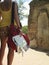 Woman By Ancient Ruins With Guidebook