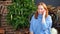 A woman answers the phone near the Christmas tree. congratulations to friends.