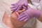 Woman on anti-aging procedure in a beauty salon. Facial skin cleansing in a cosmetology center. The movement of the hands of the