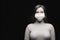 A woman in an anti-injection mask , protection from covid 2019 coronavirus . young and beautiful, female portrait on a