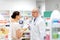 Woman and apothecary with prescription at pharmacy