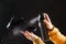 A woman applies a spray from a cylinder with a water-repellent liquid to children's crumbs. Care for shoes