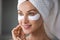 Woman apply anti wrinkle hydrogel eyes patches closeup portrait