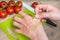 Woman apply plaster on her hand - injury in kitchen