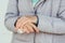 Woman applying alcohol spray against coronavirus. Closeup of female hand disinfecting hands with antiseptic spray, outdoors