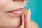 Woman applying balsam for lips