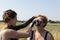 Woman applying clay on her mother face