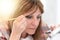 Woman applying eyeshadow powder, light effect