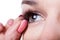 Woman applying false eyelashes