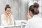 Woman applying foam for washing on her face and looking at the mirror