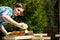 Woman applying fresh wood treatment paint