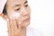 Woman applying lotion skin serum cream on face after shower. Moisturizer skin care for moisturized reduce wrinkles and protection