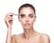 Woman applying mascara makeup on eyes by brush