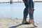 Woman applying mineral blue mud on legs at Sivash lake