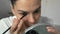 Woman applying paint on eyebrows making beauty procedure at home, closeup view.