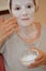 Woman applying pearl powder mask