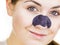 Woman applying pore strips on nose