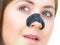 Woman applying pore strips on nose