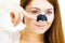 Woman applying pore strips on nose