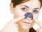 Woman applying pore strips on nose