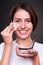 Woman applying powder on her skin