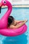 Woman applying sunscreen at sunny summer poolside