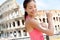 Woman applying sunscreen suntan lotion, Colosseum