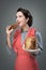 Woman in apron eating panettone