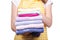 Woman in apron in hands stack towels laundry clothes