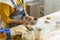 Woman in apron shaping pottery in art studio, making clay mug during ceramics masterclass