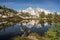 Woman with arms outstretched on mountain. One person looking at view scenic lake alpine landscape summer vacation fitness