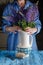 Woman arranges spring flower bouquet in a vase