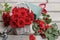 Woman arranging bouquet of red roses