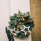 Woman arranging christmas wreath on the outside wall