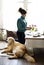 Woman Arranging Flowers with Golden Retriever Dog Laying