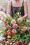 Woman arranging a huge floral decoration