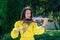 Woman artist with dark hair in a dress plays a wooden concert electric violin