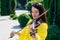 Woman artist with dark hair in a dress plays a wooden concert electric violin