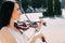 Woman artist with dark hair in a dress plays a wooden concert electric violin