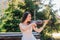 Woman artist with dark hair in a dress plays a wooden concert electric violin