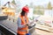 Woman as an architect on construction site looks at checklist