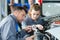 Woman as mechanic apprentice in auto repair shop