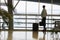 Woman as a passenger in the waiting area in the airport terminal