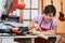 Woman as trainee learns guitar making art