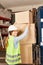 Woman as a warehouse worker Trainee stacks packages