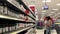 Woman asking worker about health food question at pharmacy section